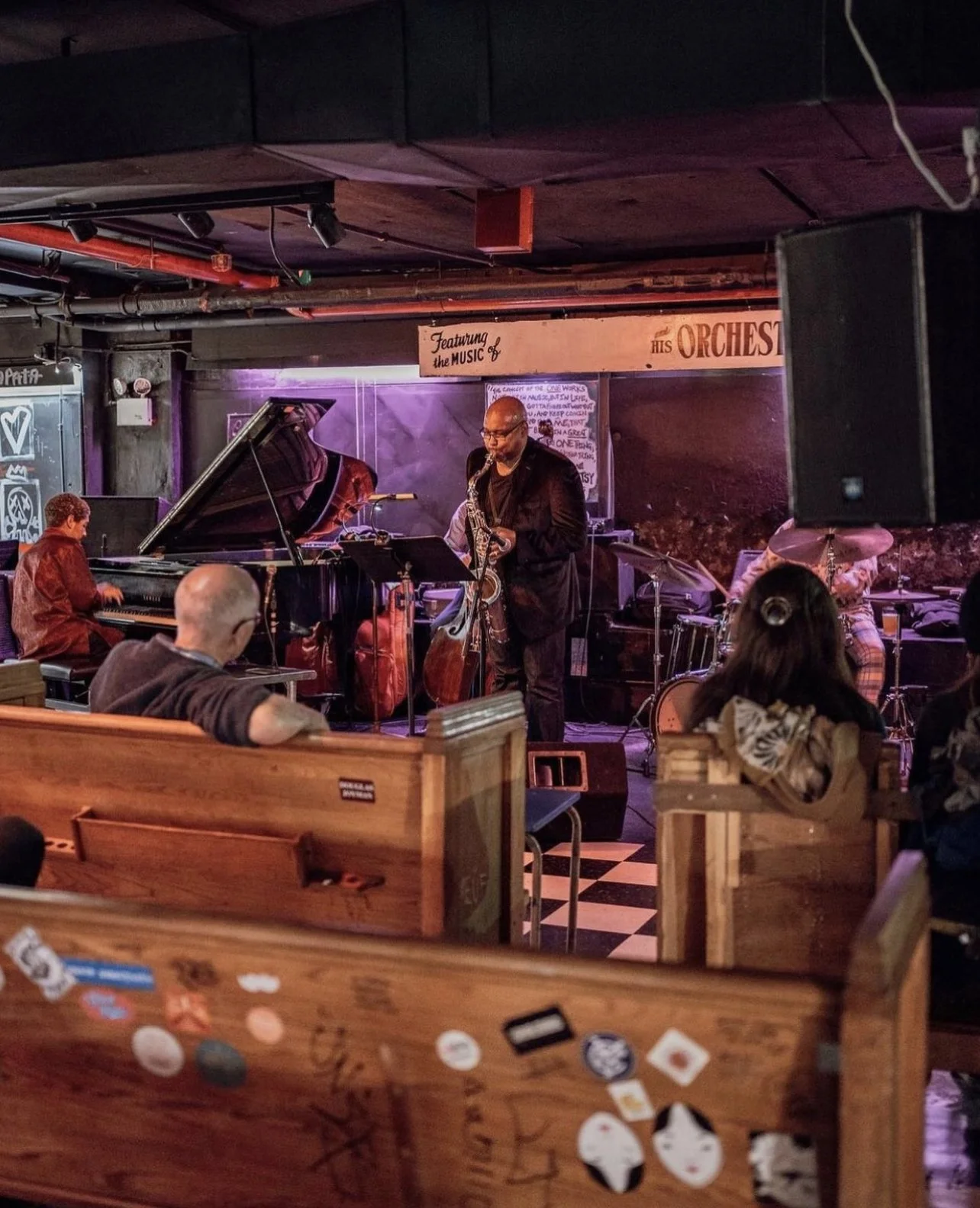 Band performing to a crowd at Cellar Dog