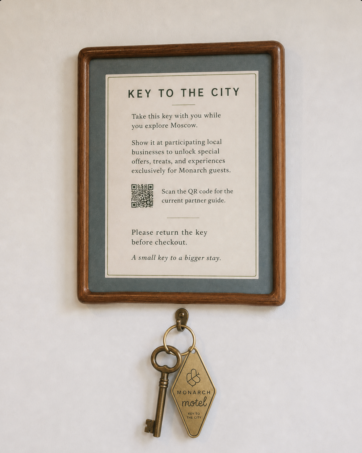 Framed Key to the City instructions installed above the key in a guest room